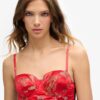 Top a corsetto con ricami floreali in raso
