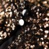 Top corto a maniche lunghe con paillettes